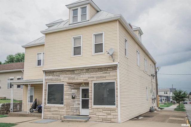727-729 Monroe St, Quincy, IL 62301 - rear view of property with stone siding, a metal roof, a standing seam roof, and entry steps