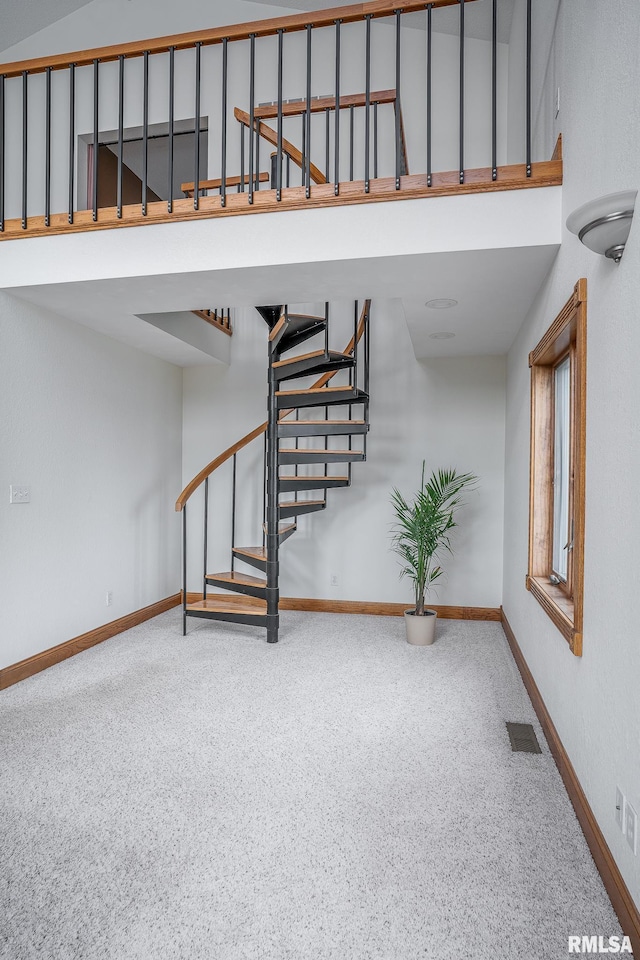 4460 160th St, Clinton, IA 52732 - staircase featuring carpet flooring and a high ceiling
