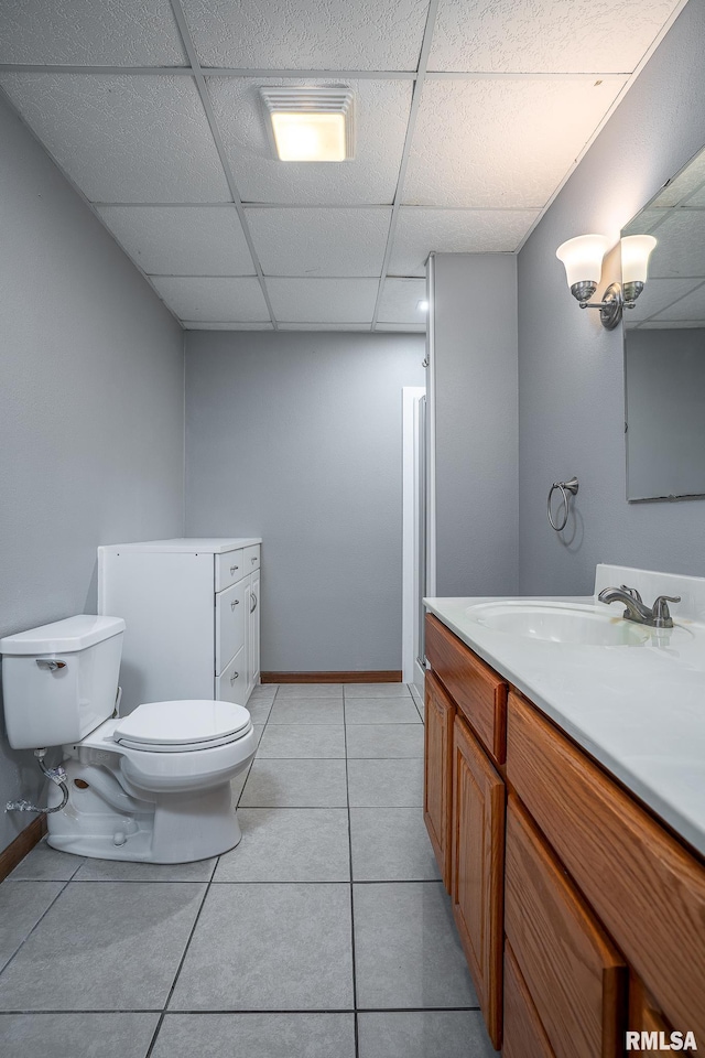 4460 160th St, Clinton, IA 52732 - bathroom featuring a drop ceiling, vanity, and tile patterned flooring