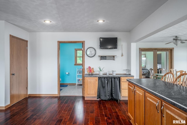 4460 160th St, Clinton, IA 52732 - kitchen with dark countertops, dark wood-type flooring, a ceiling fan, recessed lighting, and brown cabinetry