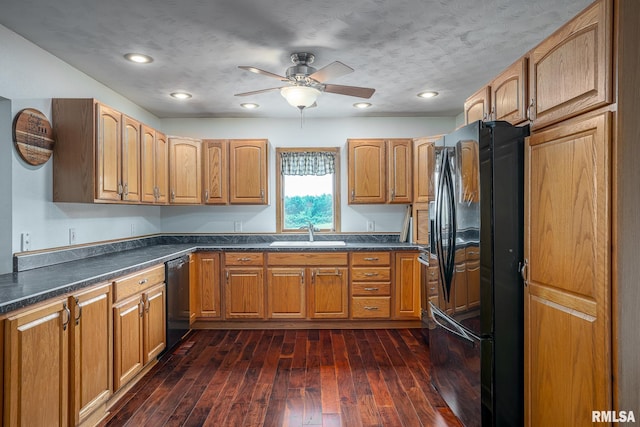 4460 160th St, Clinton, IA 52732 - kitchen with black appliances, dark countertops, ceiling fan, dark wood-style flooring, and recessed lighting