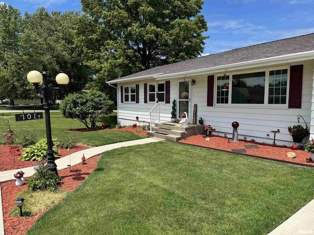 101 E 6th St, Sherrard, IL 61281 - view of front of property featuring a front lawn and roof with shingles