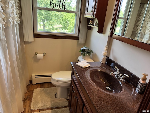 101 E 6th St, Sherrard, IL 61281 - full bath with a baseboard heating unit, healthy amount of natural light, vanity, and wood finished floors