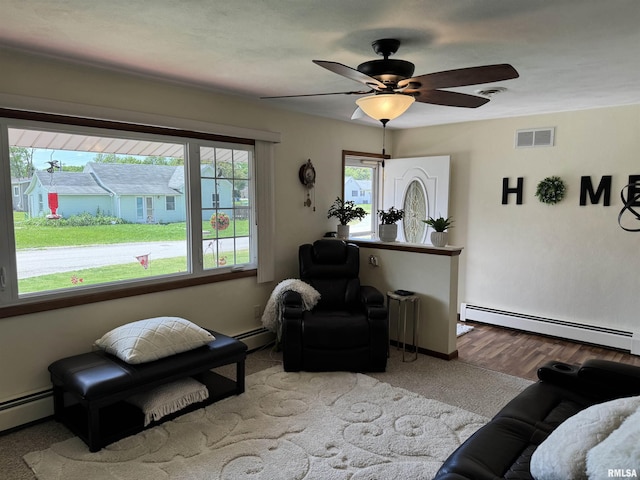 101 E 6th St, Sherrard, IL 61281 - living room featuring a baseboard radiator and ceiling fan
