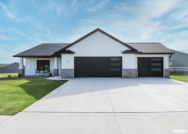 624 Rock Point Rd, Colona, IL 61241 - modern farmhouse style home with an attached garage, a front lawn, stone siding, and concrete driveway