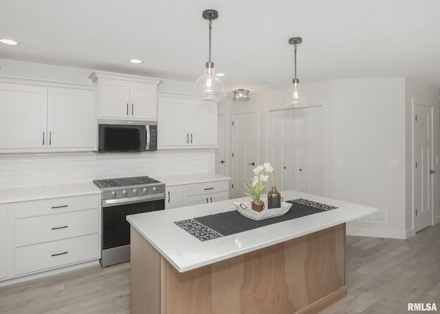 624 Rock Point Rd, Colona, IL 61241 - kitchen with appliances with stainless steel finishes, white cabinetry, tasteful backsplash, light wood finished floors, and recessed lighting