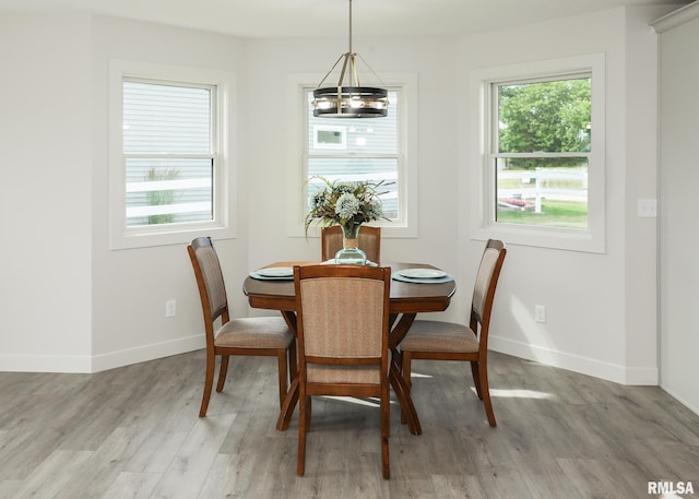 624 Rock Point Rd, Colona, IL 61241 - dining area featuring light wood-type flooring and a chandelier
