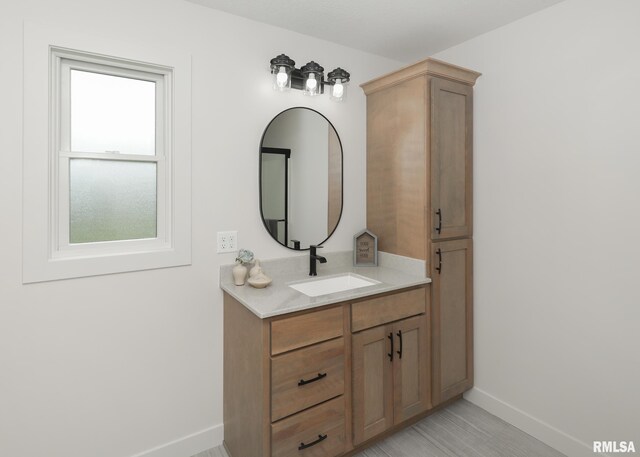 624 Rock Point Rd, Colona, IL 61241 - bathroom featuring baseboards and vanity
