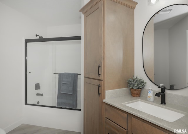 624 Rock Point Rd, Colona, IL 61241 - full bathroom featuring vanity,  shower combination, and wood finished floors