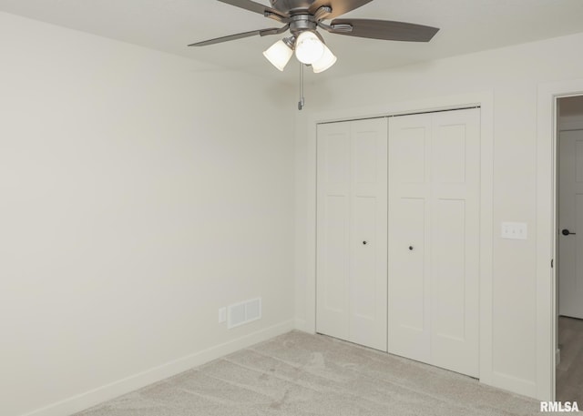 624 Rock Point Rd, Colona, IL 61241 - unfurnished bedroom featuring light carpet, a closet, and a ceiling fan