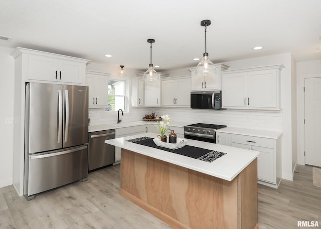624 Rock Point Rd, Colona, IL 61241 - kitchen with appliances with stainless steel finishes, light wood-type flooring, white cabinetry, light countertops, and recessed lighting