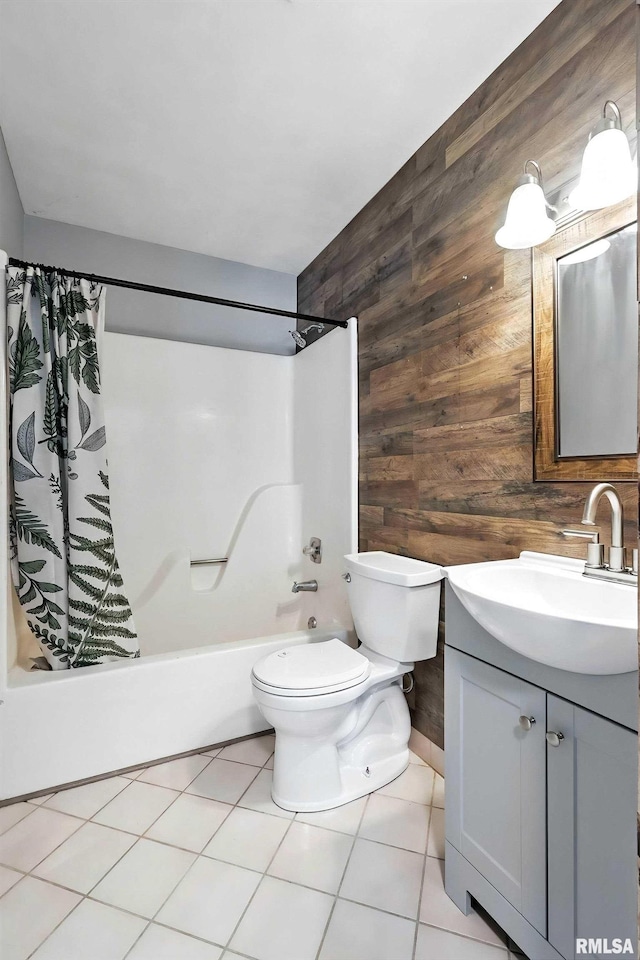 3045 4th St Unit 1, Moline, IL 61265 - bathroom with wood walls, vanity, shower / bath combo, and tile patterned floors