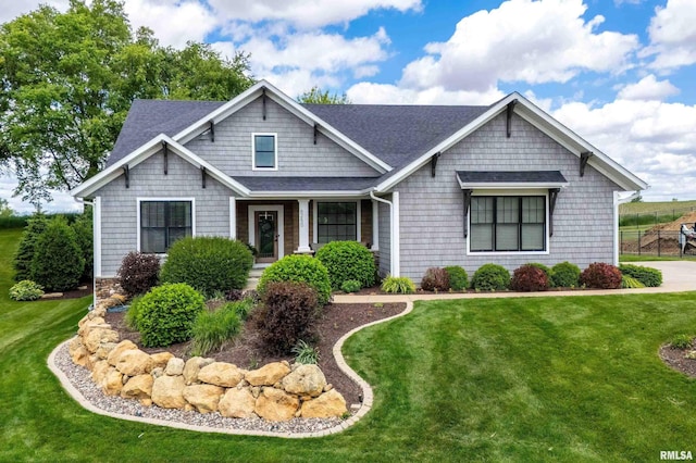 6250 Whispering Hill Ct, Bettendorf, IA 52722 - craftsman-style house featuring roof with shingles and a front yard