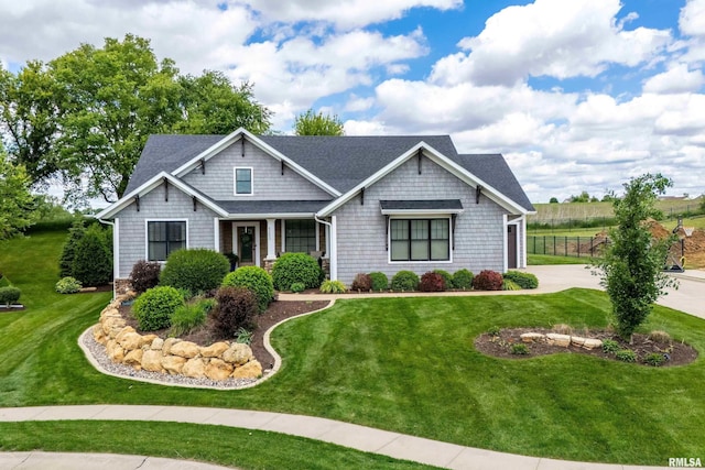 6250 Whispering Hill Ct, Bettendorf, IA 52722 - craftsman house featuring a front lawn and a shingled roof