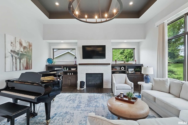 6250 Whispering Hill Ct, Bettendorf, IA 52722 - living room featuring healthy amount of natural light, wood finished floors, a tray ceiling, and recessed lighting