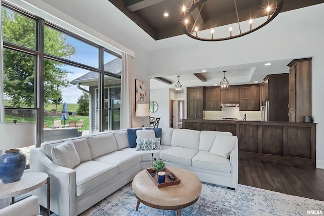 6250 Whispering Hill Ct, Bettendorf, IA 52722 - living room featuring a raised ceiling, wood finished floors, recessed lighting, and a chandelier