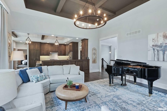 6250 Whispering Hill Ct, Bettendorf, IA 52722 - living room featuring coffered ceiling, dark wood-style flooring, a chandelier, beam ceiling, and a raised ceiling