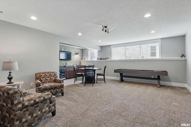 6250 Whispering Hill Ct, Bettendorf, IA 52722 - living room featuring wet bar, light colored carpet, recessed lighting, and a textured ceiling