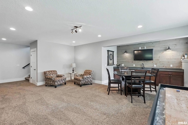 6250 Whispering Hill Ct, Bettendorf, IA 52722 - dining room with stairs, recessed lighting, carpet, bar, and a textured ceiling
