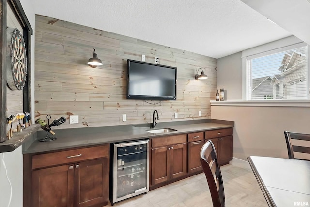 6250 Whispering Hill Ct, Bettendorf, IA 52722 - bar featuring wine cooler, wood walls, and a textured ceiling