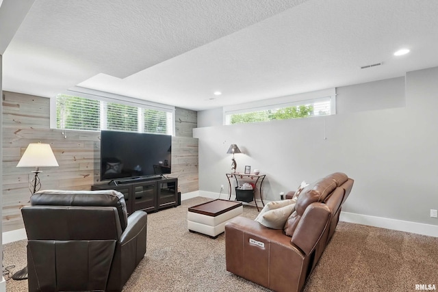 6250 Whispering Hill Ct, Bettendorf, IA 52722 - living area featuring wood walls, recessed lighting, carpet floors, and a textured ceiling