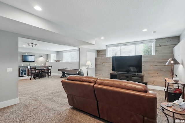 6250 Whispering Hill Ct, Bettendorf, IA 52722 - living room with wood walls, carpet floors, recessed lighting, healthy amount of natural light, and an accent wall