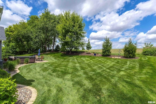 6250 Whispering Hill Ct, Bettendorf, IA 52722 - view of green lawn with a patio