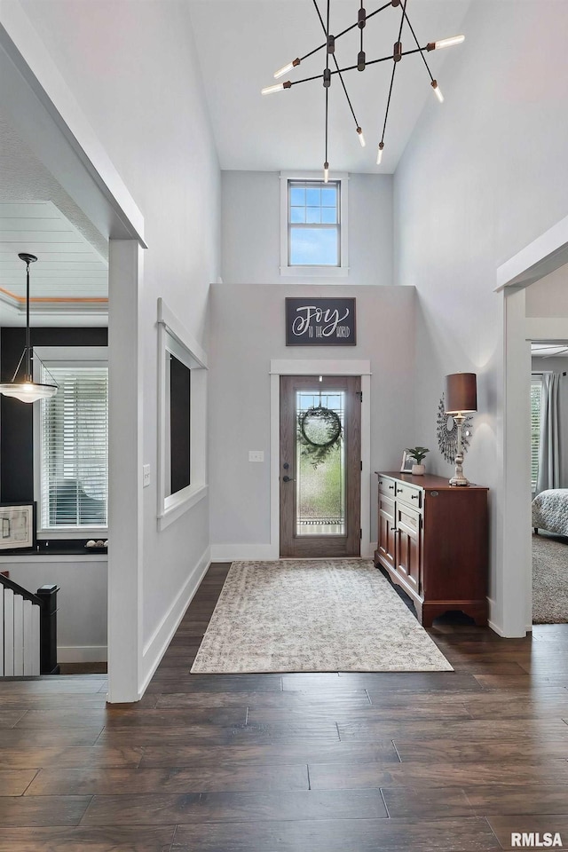 6250 Whispering Hill Ct, Bettendorf, IA 52722 - entrance foyer featuring high vaulted ceiling, a chandelier, wood finished floors, and radiator heating unit