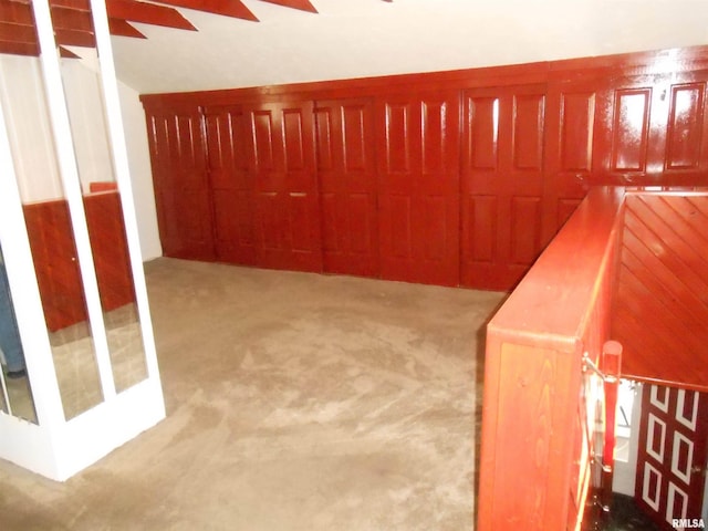 636 3rd St, Buffalo, IA 52728 - unfurnished bedroom featuring carpet, lofted ceiling, and a ceiling fan