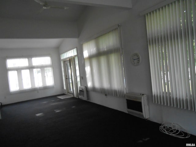 636 3rd St, Buffalo, IA 52728 - unfurnished living room with heating unit, carpet floors, and vaulted ceiling