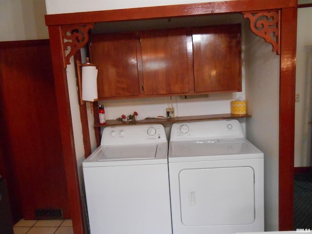 636 3rd St, Buffalo, IA 52728 - washroom with washing machine and dryer, cabinet space, and light tile patterned flooring