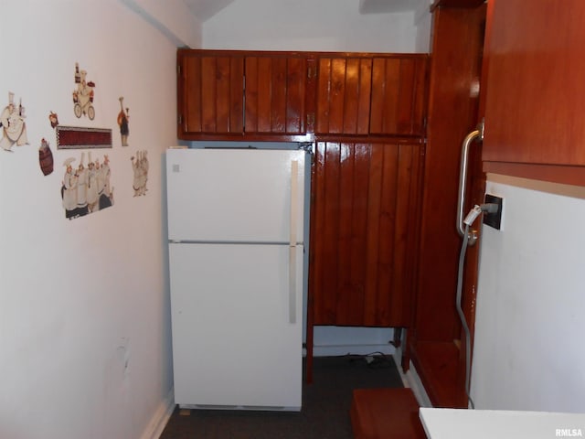 636 3rd St, Buffalo, IA 52728 - kitchen featuring freestanding refrigerator and brown cabinets