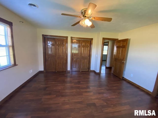 1501 Erinberry St, Marion, IL 62959 - unfurnished bedroom with two closets, wood finished floors, and a ceiling fan
