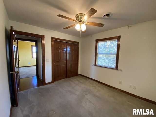 1501 Erinberry St, Marion, IL 62959 - unfurnished bedroom with carpet, multiple windows, a closet, and ceiling fan