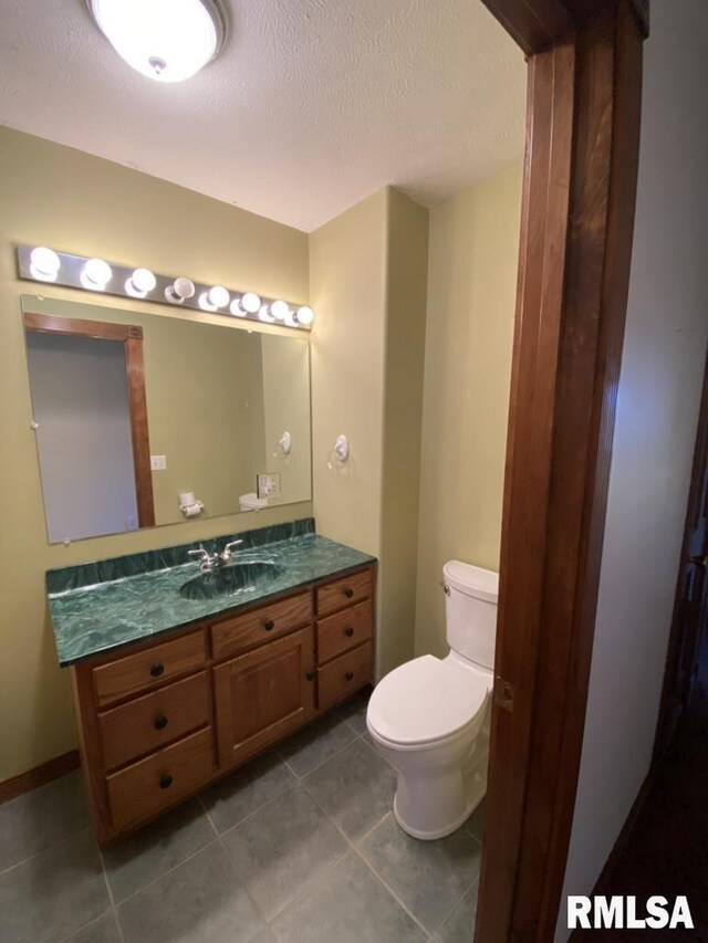 1501 Erinberry St, Marion, IL 62959 - bathroom featuring vanity, a textured ceiling, and tile patterned flooring