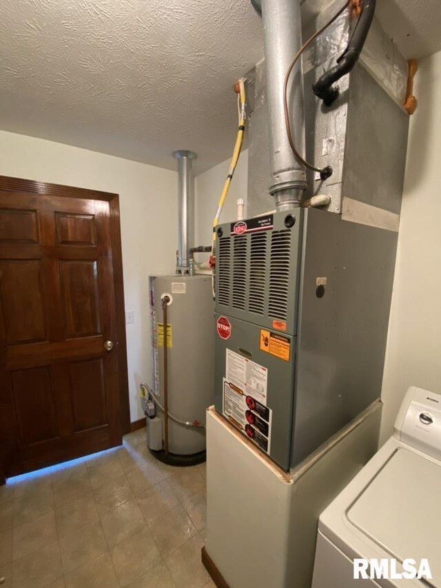 1501 Erinberry St, Marion, IL 62959 - utility room with gas water heater, washer / clothes dryer, and heating unit