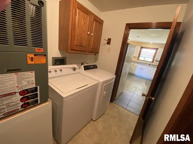 1501 Erinberry St, Marion, IL 62959 - washroom featuring cabinet space, a heating unit, separate washer and dryer, and light tile patterned floors