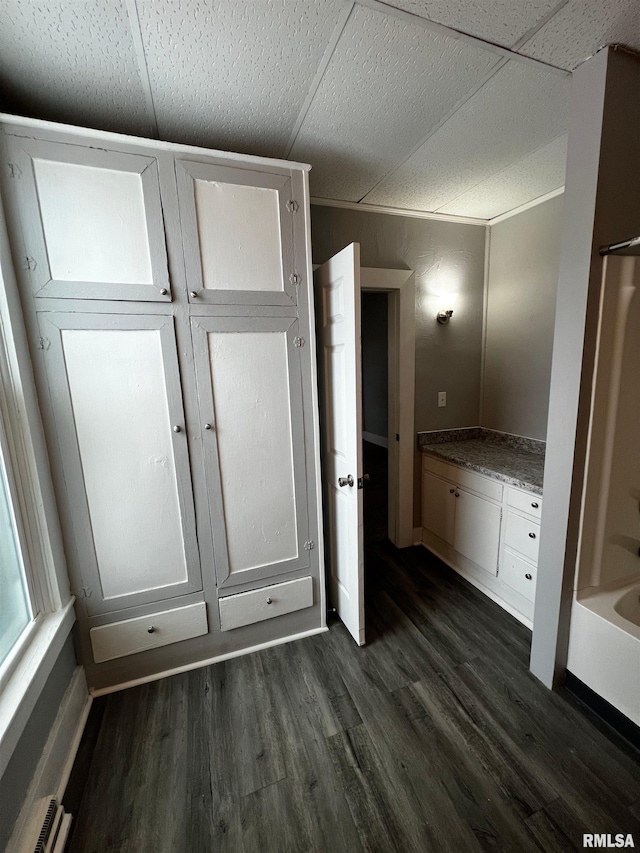 201 N 20th St, East Moline, IL 61244 - bathroom with wood finished floors, baseboard heating, and a bath