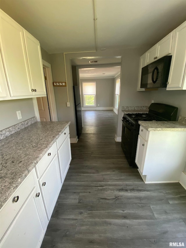 201 N 20th St, East Moline, IL 61244 - kitchen featuring black appliances, white cabinetry, dark wood finished floors, and light stone countertops