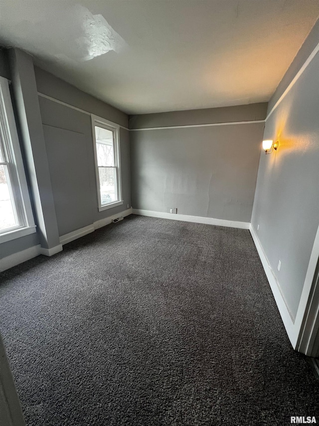 201 N 20th St, East Moline, IL 61244 - unfurnished room with dark colored carpet and baseboards