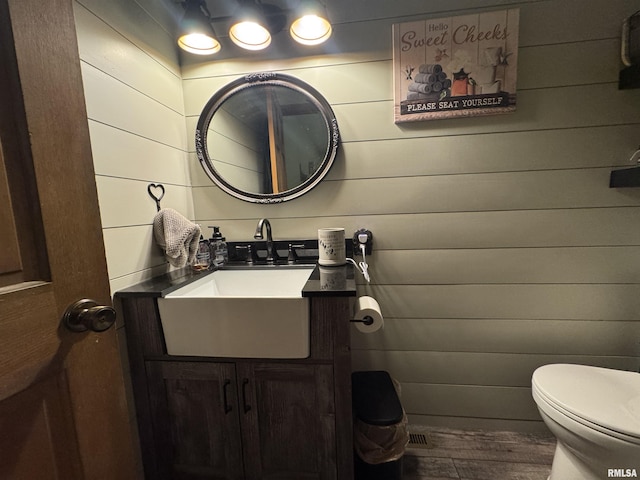 5560 Hidden Acres Ln, Carterville, IL 62918 - half bath featuring wood finished floors, vanity, and wooden walls