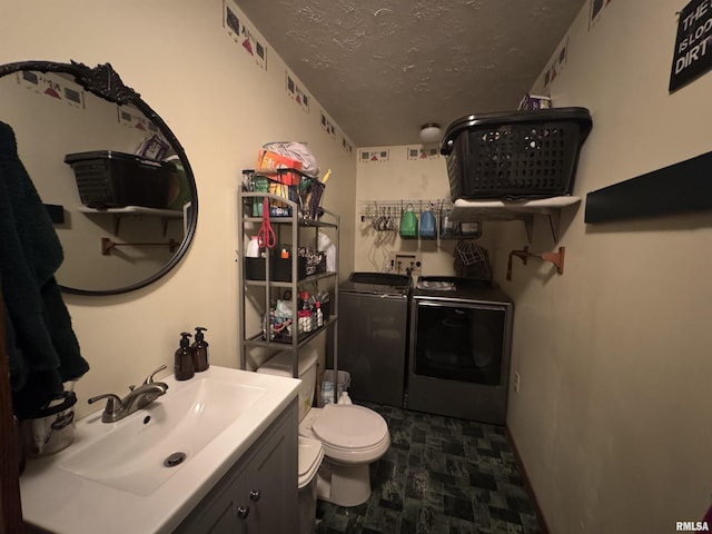 5560 Hidden Acres Ln, Carterville, IL 62918 - bathroom featuring separate washer and dryer, a textured ceiling, and vanity