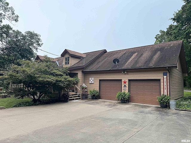 5560 Hidden Acres Ln, Carterville, IL 62918 - view of front of property featuring a garage, driveway, and roof with shingles