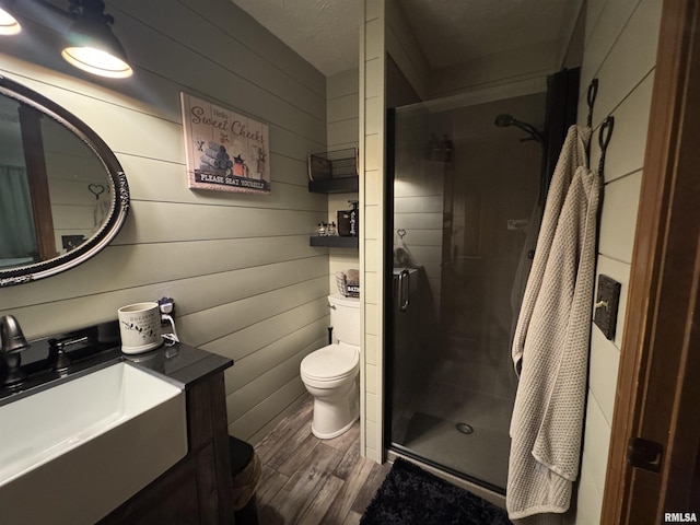 5560 Hidden Acres Ln, Carterville, IL 62918 - bathroom with wood finished floors, a stall shower, vanity, and wooden walls