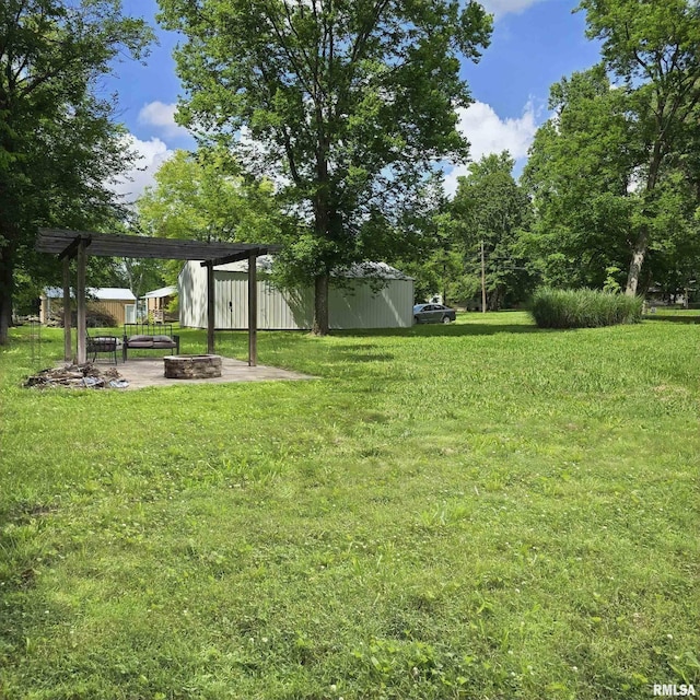 314 Chestnut St, Cambria, IL 62915 - view of green lawn with a fire pit, an outdoor structure, and a pole building