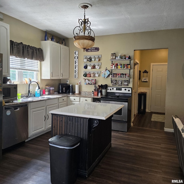 314 Chestnut St, Cambria, IL 62915 - kitchen with appliances with stainless steel finishes, dark wood-type flooring, white cabinets, light countertops, and a textured ceiling
