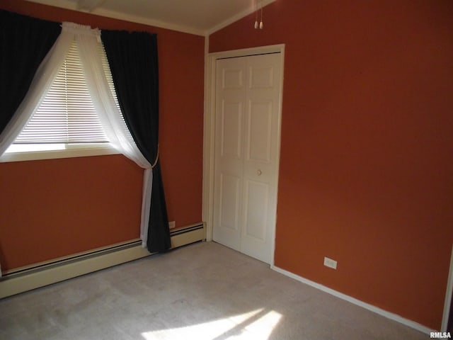 619 E 6th St, Tipton, IA 52772 - unfurnished bedroom with a baseboard radiator, carpet, and lofted ceiling