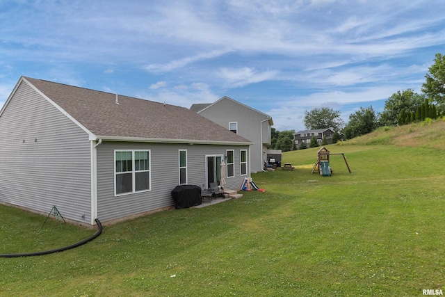 3458 Glenbrook Cir N, Bettendorf, IA 52722 - back of property with a lawn, a patio area, and a shingled roof