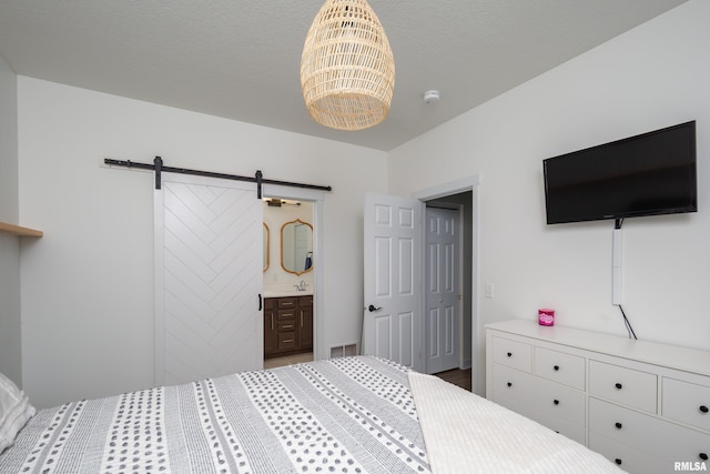 3458 Glenbrook Cir N, Bettendorf, IA 52722 - bedroom with a barn door, a chandelier, and ensuite bathroom