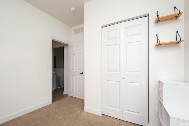 3458 Glenbrook Cir N, Bettendorf, IA 52722 - unfurnished bedroom featuring light carpet and a closet